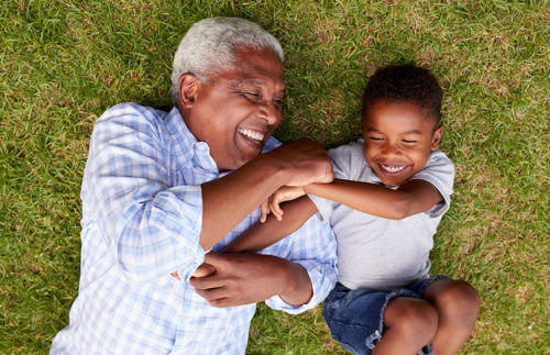 grandpa and grandson playing in yard